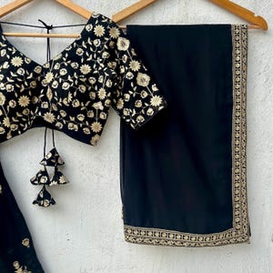 Navy Blue Georgette Partywear Lehenga Set + Antique Gold Flapover Handembroidered Clutch + White Choker Set With Pearls - Rent main image 1