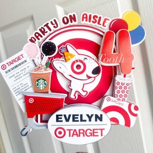 May include: A colorful birthday party decoration featuring the Target logo, a cartoon dog, and the text "Party on Aisle." Includes a Starbucks cup, a gift card, and the name "Evelyn."
