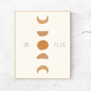 May include: A minimalist print with a white background and a vertical arrangement of five brown watercolor moon phases. The text "UNPLUG" is on the right side and "UN" is on the left side.