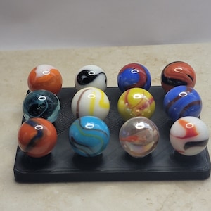 12 glass game marbles and display see photos for imperfections - lot #4341