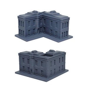 May include: A gray 3D printed model of a corner building with a flat roof and multiple windows. The building has a detailed facade with decorative trim.