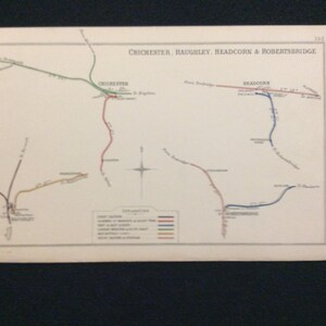 May include: A vintage map of train lines in the United Kingdom, showing the routes of the Chichester, Haughley, Headcorn & Robertsbridge Railway. The map is printed on cream paper and features a compass rose and a key explaining the different lines.