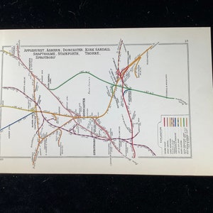 May include: A vintage map featuring a colorful railway network, with lines in various colors such as red, green, and yellow. The map includes place names like Doncaster and Thorne, and the number 25 is visible in the upper right corner.