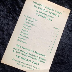 May include: A vintage brochure titled "Holiday Period Fares to Seaside Resorts" from Summer 1964. The brochure lists destinations like Blackpool and Scarborough, with fares at off-peak prices. The text is printed in green on a cream-colored paper.