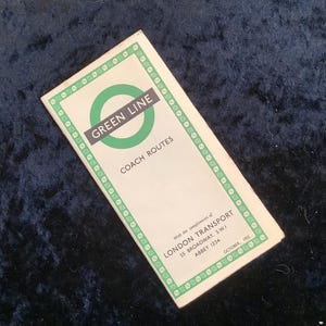 May include: A vintage Green Line coach route map booklet with a green circle logo and the text "GREEN LINE" and "COACH ROUTES". The booklet is printed on white paper with a green border and the text "With the compliments of LONDON TRANSPORT 55 BROADWAY, S.W.I ABBEY 1234 OCTOBER, 1955".
