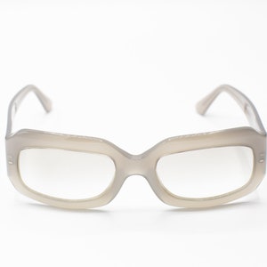 May include: A pair of gray plastic framed eyeglasses with clear lenses.