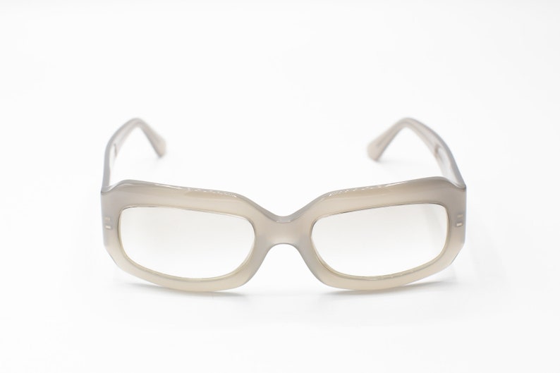 May include: A pair of gray plastic framed eyeglasses with clear lenses.