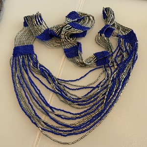 A delightful vintage handmade tribal, ethnic style micro beaded woven necklace in contrasting metallic grey and blue colour.