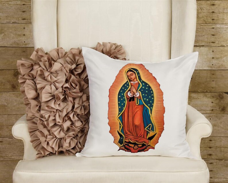May include: White pillow with a colorful image of the Virgin Mary of Guadalupe. The image is surrounded by a golden halo with blue stars.