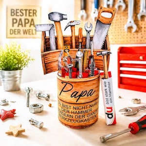Puede incluir: Una caja de herramientas de madera y un recipiente cilíndrico con la palabra "Papa", lleno de varias herramientas como martillos, una sierra y llaves. La imagen también incluye un letrero que dice "BESTER PAPA DER WELT".