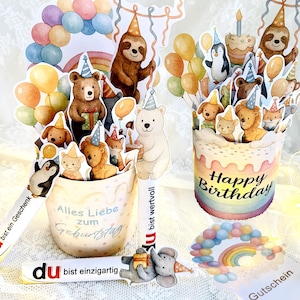 Pode incluir: Cartões pop-up com tema de aniversário com vários personagens de animais, incluindo ursos, bichos-preguiça e pinguins, com chapéus de festa e balões. Um cartão diz "Happy Birthday", outro "Alles Liebe zum Geburtstag".