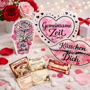 May include: A romantic arrangement featuring a bouquet of red and pink roses, decorative heart-shaped and lip-shaped cutouts with German text, and gift certificates. The heart-shaped cutout has the text "Gemeinsame Zeit". The lip-shaped cutout has the text "Küsschen für Dich".