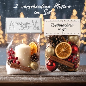 May include: Two clear cellophane bags filled with Christmas decorations. One bag contains a white candle, dried orange slices, pine cones, red berries, and a gold ornament. The other bag has ornaments, pine cones, cinnamon sticks, and dried orange slices. Each bag has a tag that says "Weihnachten to go".