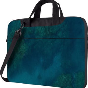 May include: A laptop bag with a teal and dark green ocean-themed design. The bag has a black handle and a detachable black shoulder strap. The bag is rectangular with a zipper closure and a black border.