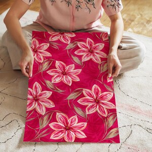 May include: A striking floral design with large pink flowers, white highlights, and green leaves set against a deep magenta backdrop. The pattern repeats across the surface, creating a bold and visually appealing aesthetic.
