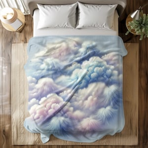 May include: A soft blue and white blanket with a cloud pattern. The blanket is made of a plush material and has a fluffy texture.