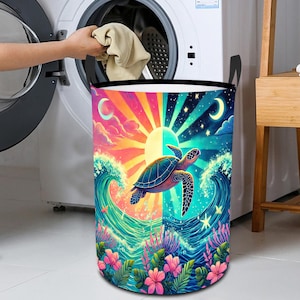 Könnte beinhalten: Ein farbenfroher Wäschekorb mit einem Motiv einer Meeresschildkröte, die im Meer schwimmt. Das Design zeigt einen Sonnenaufgang und einen Sonnenuntergang auf beiden Seiten der Schildkröte, umgeben von Wellen und Blumen.