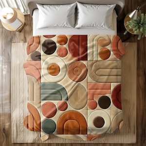 Könnte beinhalten: Ein beigefarbener Bettbezug mit einem geometrischen Muster aus Kreisen, Bögen und Rechtecken in Braun-, Orange- und Grüntönen.