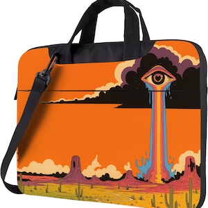 May include: Laptop bag with a desert landscape design. The bag features an orange sky, cacti, and rock formations. A large eye with rainbow tears is in the center. It has a black shoulder strap and handles.