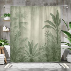 May include: A sage green shower curtain featuring a tropical jungle design. The curtain showcases various palm leaves and other tropical foliage in shades of green against a muted background. The design creates a serene, nature-inspired aesthetic for the bathroom.