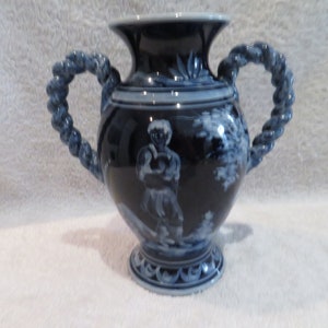 Pretty vase with twisted coves faience of Nevers Jean Montagnon character décor on blue background of Nevers