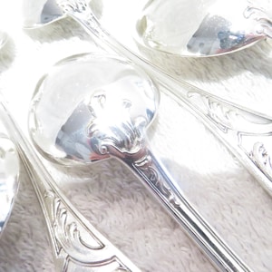 12 silver metal soup spoons art nouveau rococo goldsmith Grand Magasin du Louvre early 20th c French silver-plated soup spoons