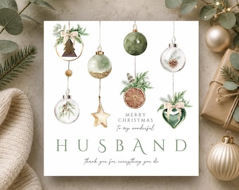 May include: A square greeting card featuring watercolor illustrations of hanging Christmas ornaments, including glass baubles, a star, and a dried orange slice. The text reads Merry Christmas to my wonderful HUSBAND Thank you for everything you do.