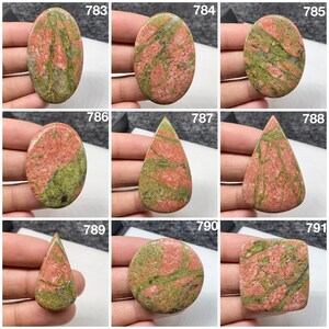 May include: A collection of nine polished unakite cabochons labeled 783 through 791, featuring a mottled pattern of salmon pink and olive green mineral inclusions in various shapes including oval, teardrop, circular, and square silhouettes.