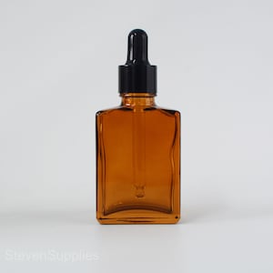 May include: Amber glass bottle with a black dropper top. The bottle is square shaped and has a clear glass dropper.
