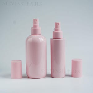 May include: Two light pink plastic spray bottles with matching removable caps. The bottles feature a smooth, opaque finish and a pump sprayer mechanism. The text STEVENSUPPLIES is visible in the upper left and lower right corners of the image.