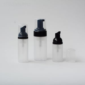 May include: Three clear plastic foam pump bottles with black and dark blue pump tops. The bottles are different sizes, with one having a detached cap. The text "STEVENSSUPPLY" is visible in the top left corner.