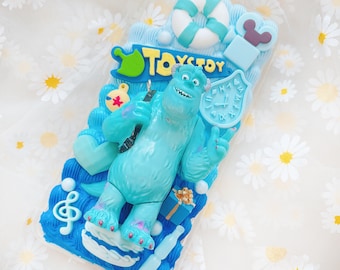 May include: A blue and white phone case with a 3D design of Sully from Monsters Inc. The case features a blue and white background with a 3D design of Sully, a blue monster with a single eye. The case also features a blue and white clock, a blue and white life preserver, and the text "Toy Story".