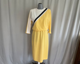 Yellow 1970s knit dress with asymmetrical top, yellow black and white 1960s casual dress with shoulder pads