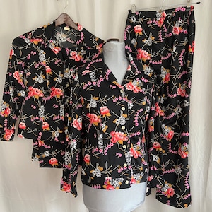 Pair of identical black floral vintage pant suits, twin groovy womens pant suits, two polyester womens suits, matching womens vintage suits