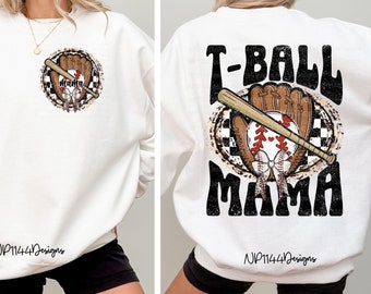 May include: White sweatshirt with a graphic of a baseball glove, bat, and baseball with the text "T-BALL MAMA" in black and white. The sweatshirt has the text "NP1144Designs" in black on the bottom.