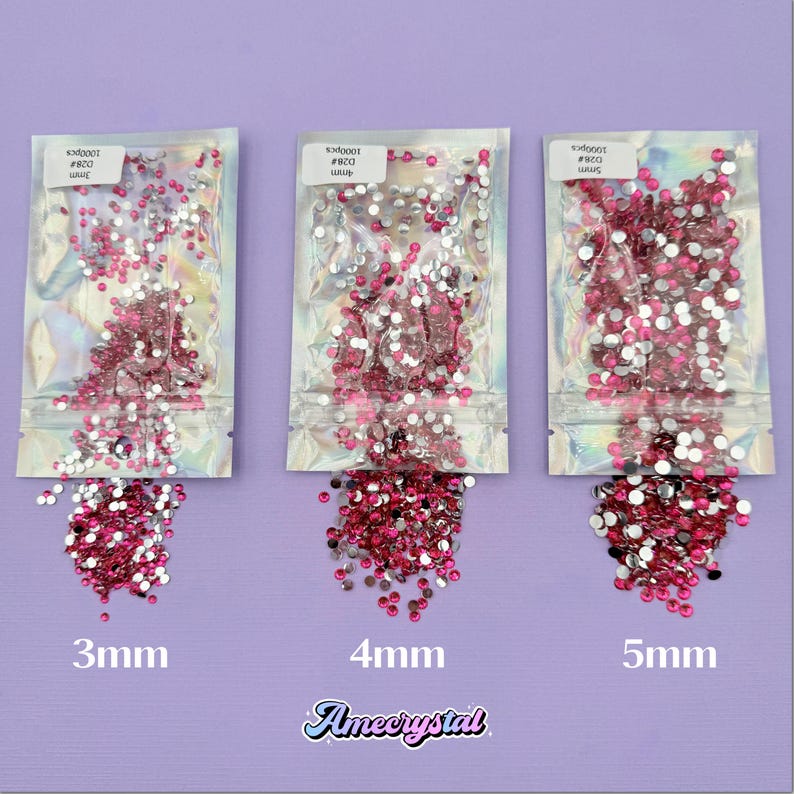 May include: Three bags of pink and silver rhinestones, labeled 3mm, 4mm, and 5mm. The rhinestones are spilling out of the bags.