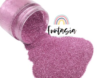 May include: A jar of pink glitter is tipped over, spilling out onto a white background. The glitter is fine and shimmery, with a slight iridescent quality. The jar is clear plastic with a black lid. The text "Fantasia" is visible on the jar, along with the words "Kawaii Resin Crafts".