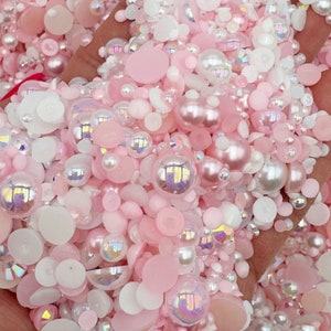 May include: A mix of pink and white pearl and iridescent beads, perfect for crafting and jewelry making.
