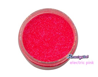 May include: A small jar of bright pink glitter with the text "Amecrystal electric pink" on the label.