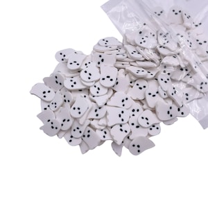 May include: A large bag of white ghost-shaped sprinkles with black eyes. The sprinkles are perfect for decorating cakes, cupcakes, and other treats for Halloween.