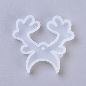 May include: White silicone mold shaped like a reindeer head with antlers. The mold is designed for making resin crafts.