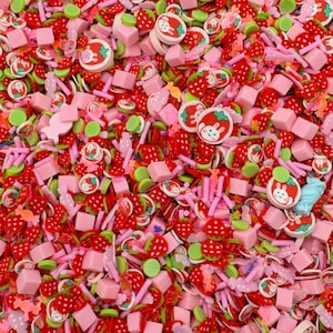 May include: A vibrant assortment of colorful polymer clay pieces. The mix includes red strawberry slices, pink cubes, green circles, and round pieces with a bunny and strawberry design. Also present are pink sticks, butterflies, and other shapes.