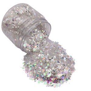 May include: A clear plastic jar filled with iridescent white glitter. The glitter is spilling out of the jar, creating a pile of glitter on a white background.