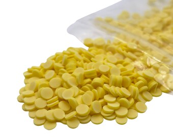 May include: A bag of yellow round sprinkles, perfect for decorating cakes, cookies, and other treats.