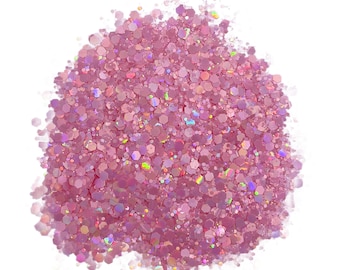 May include: A pile of pink iridescent glitter with a variety of sizes and shapes.