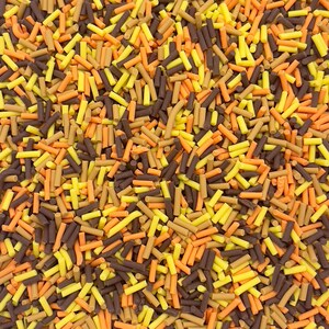 May include: A close-up of a variety of colorful sprinkles. The sprinkles are a mix of brown, orange, and yellow. They are all long and thin, and they are perfect for decorating cakes, cupcakes, and other desserts.