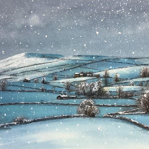 May include: A watercolour painting of a snowy landscape with rolling hills, a few houses, and trees. The sky is a light blue with white snow falling.