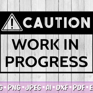 May include: Black and white caution sign with a triangle and exclamation point. The sign reads "CAUTION WORK IN PROGRESS".