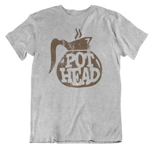 May include: A gray t-shirt with a brown graphic of a coffee pot with the text "POT HEAD" printed on it.