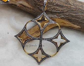 May include: A gold and black pendant with a geometric design featuring four open circles and four star shapes. The pendant is set with small black diamonds.